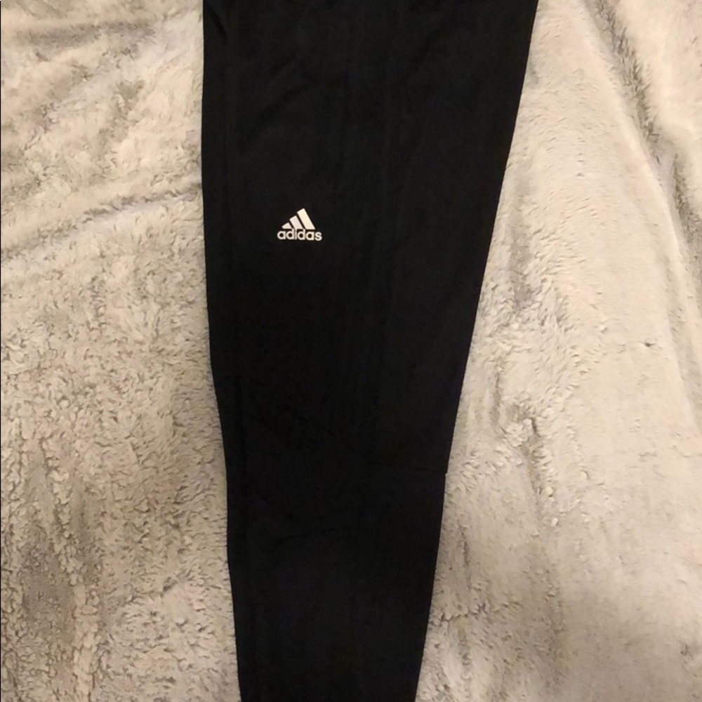 Women all black Adidas joggers with zipper pockets